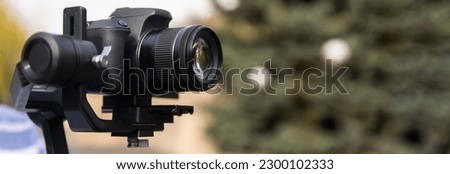 The camera is on a stabilizer for video shooting