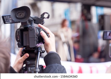 Camera Operator Recording Female Speaker At Public Protest