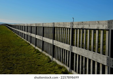 camera post protecting against the entry of other animals. visitors enter through a barred stainless steel gate. fence, noise protection. poles of the palisade are locked into steel beams - Shutterstock ID 2257898699