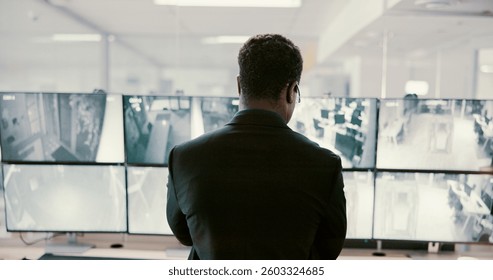 Camera, security and back of man on computer screen for surveillance, inspection and monitoring. Observation, footage and guard on monitor for protection, info and building safety in control room