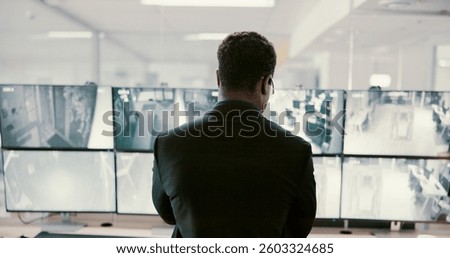 Camera, security and back of man on computer screen for surveillance, inspection and monitoring. Observation, footage and guard on monitor for protection, info and building safety in control room