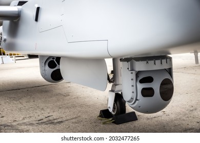 Camera sensor pods under an unmanned aerial surveillance drone aircraft.