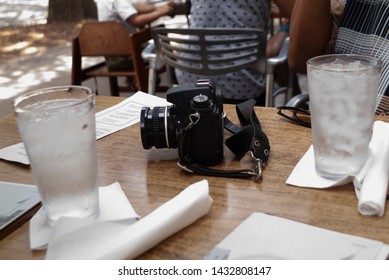 A camera sits on a restaurant table.