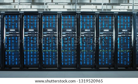 Camera Slide-Trough Shot of a Working Data Center With Rows of Rack Servers. Led Lights Blinking and Computers are Working.