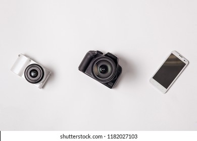 Camera, Smartphone And SLR Camera On White Isolated Background.