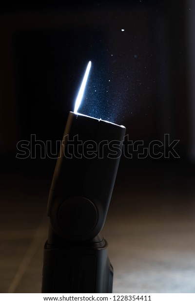 A Camera Speed Light ( Flasher ) In Night Time With\
Water Drops