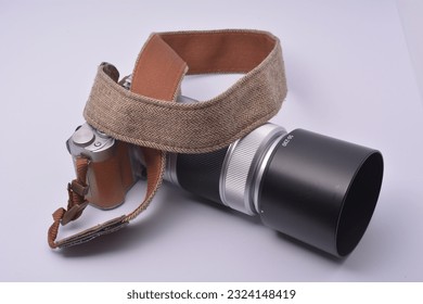 Camera and camera strap on white background