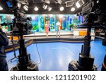 Camera in studio are broadcasting journalists reading news.Blur background have journalist or reporter.
