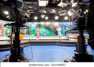 Camera in studio are broadcasting journalists reading news.Blur background have journalist or reporter.
