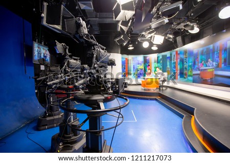 Camera in studio are broadcasting journalists reading news.Blur background have journalist or reporter.