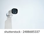 Camera, surveillance and mounted security on wall, protection and crime monitoring or criminal activity. Broadcasting, video and live feed for control room, movement detection and vigilance in office