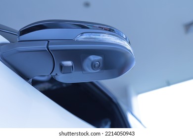 A camera system in the top view mirror helps drivers see the vehicle's blind spots to reduce road accidents. parking assist technology Transportation and Security copy space