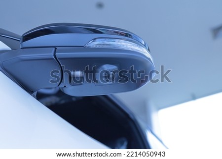 A camera system in the top view mirror helps drivers see the vehicle's blind spots to reduce road accidents. parking assist technology Transportation and Security copy space