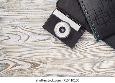 Camera tablet notebook on white wooden background isolation
