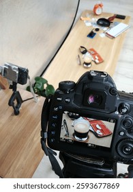 camera is taking a picture of a table with a cup of coffee and a book. The camera is on a tripod. pretag photostudio shooting screen
