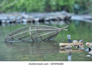 Camera in waterproof case and Fish trap  in Thailand.