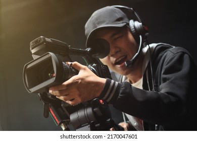 Cameraman With A Camera On A Tripod At Studio