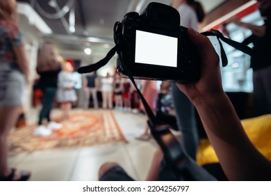 Cameraman With A Camera Works In A Business Training Class. Close-up.