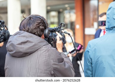 Cameraman Filming Media Event Or News Conference During Coronavirus COVID-19 Pandemic. Journalism Concept.