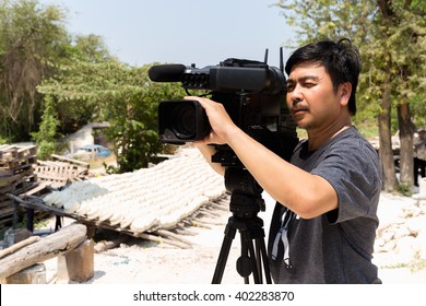 The Cameraman Filming Outdoor Event
