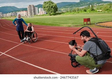 A cameraman filming the participants of the Paralympic race on the marathon course - Powered by Shutterstock