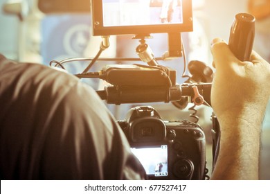 Cameraman With His Video Camera Shooting, Hands Adjusting Camera,film Production Crew,behind The Scenes Background.