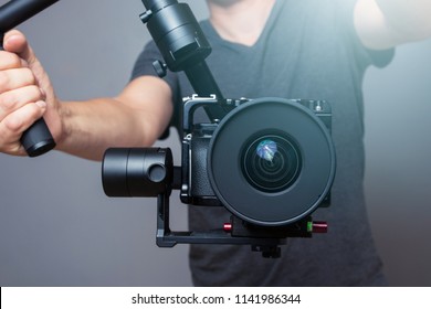 Cameraman Holding Gimbal With Slr Camera