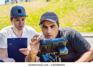 a cameraman operator discuss the shooting process with a director and dp
