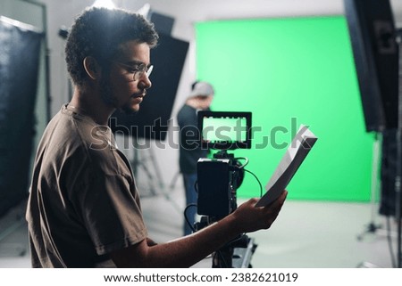 Cameraman reading script before shooting