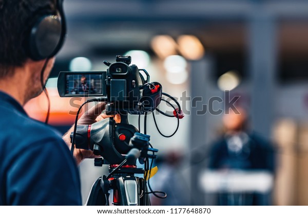 Cameraman recording at media press conference.
Live streaming
concept.