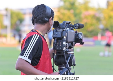 Cameraman Shooting Soccer Game.Professional Sport Media At The Stadium During Football Matches.TV Media Broadcasting During The Sport Tournament.