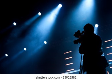 Cameraman silhouette on a concert stage