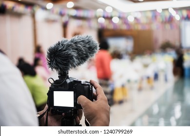 Cameraman Video Or Professional Digital Mirrorless On Tripod For Camera Recording With Microphone Taking Photograp In Wedding Convention Hall In Live Streaming Event, Seminar Production Equipment.