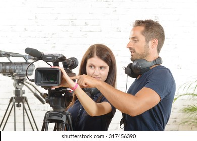 A Cameraman And A Young Woman With A Movie Camera