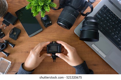 Camera's Action With Their Accessories Accompanied Of A Notebook And A Camera Reflex