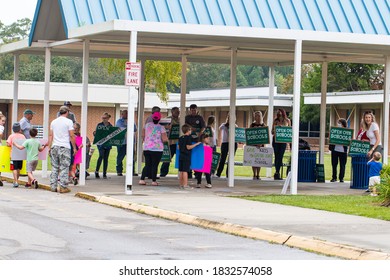 Cameron, NC/United States - 10/12/209:Parents And School-age Children, Many With “Open Our Schools” Signs, Hold A Rally Outside Union Pines High School Ahead Of A Vote By The Moore County Board Of Edu