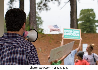 Cameron, NC/United States - 10/12/209:Parents And School-age Children, Many With “Open Our Schools” Signs, Hold A Rally Outside Union Pines High School Ahead Of A Vote By The Moore County Board Of Edu