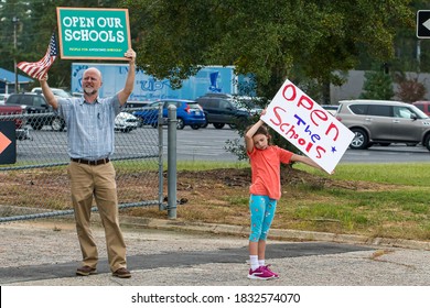 Cameron, NC/United States - 10/12/209:Parents And School-age Children, Many With “Open Our Schools” Signs, Hold A Rally Outside Union Pines High School Ahead Of A Vote By The Moore County Board Of Edu