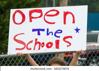 Cameron, NC/United States - 10/12/209:Parents And School-age Children, Many With “Open Our Schools” Signs, Hold A Rally Outside Union Pines High School Ahead Of A Vote By The Moore County Board Of Edu