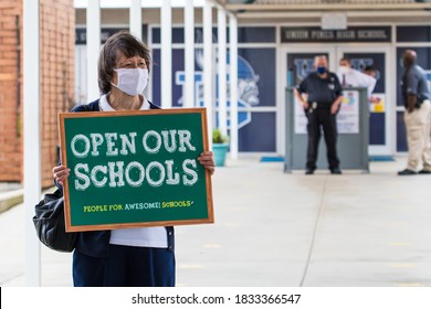 Cameron, NC/United States - 10/12/209:Parents And School-age Children, Many With “Open Our Schools” Signs, Hold A Rally Outside Union Pines High School Ahead Of A Vote By The Moore County Board Of Edu