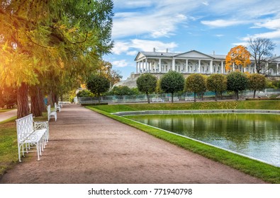 Cameron's Gallery in the Palace Park of Tsarskoe Selo and white benches among the autumn trees next to the pond