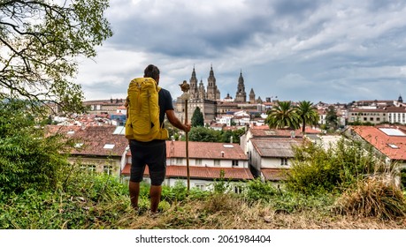 Camino de Santiago Compostela - Pilgrim ends the Way of St James pilgrimage enjoying Santiago old town cityscape, Galicia, Spain.
