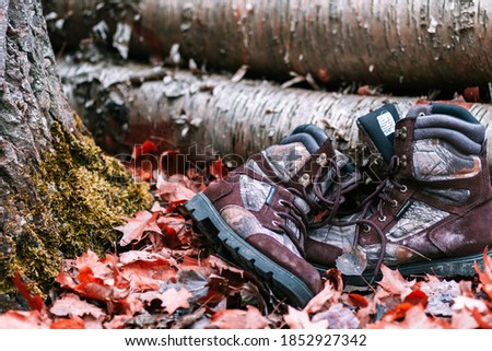 Camo hunting boots in the woods during the fall.
