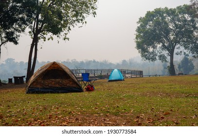 Camouflage Camping Tent And Blue Camping Chair At National Park