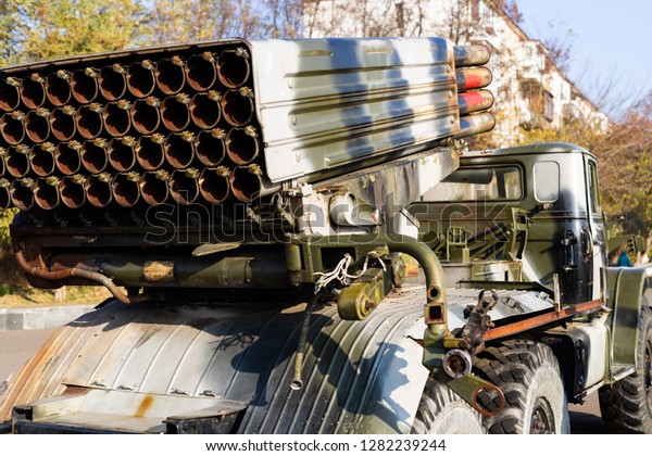Camouflage military truck with rocket launcher.
Outdoor military vehicles museum. Armor is damaged at the
battlefield. Missile firing system on military armored truck close
up view. Rocket
launcher.