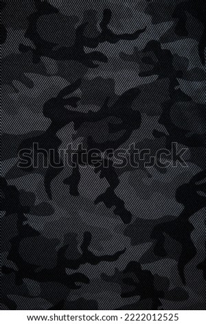 Camouflage pattern. Trendy dark gray camouflage fabric. Military texture. Dark background.
