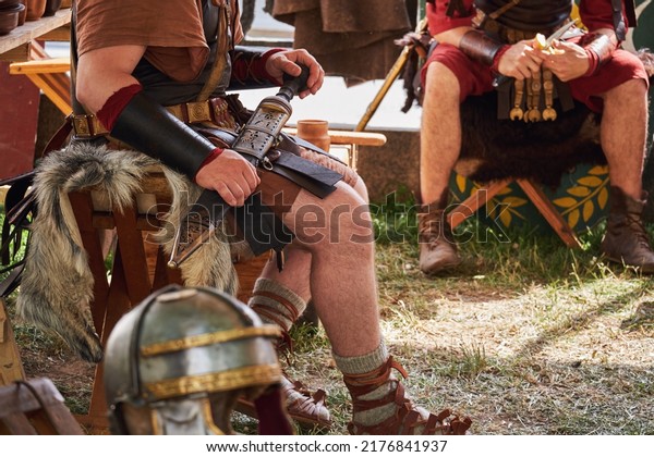 The camp of ancient Roman warriors in vintage\
clothes at a halt. Reconstruction of military events during the war\
of the Roman Empire