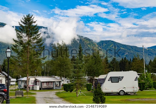 Camp. Autocamping in the mountains.\
Summer  holiday in the mountains. Camping on the background of\
mountain peaks. Austrian Alps.Tourism, active\
lifestyle