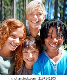 Camp Buddies. A Diverse Group Of Kids Smiiing While Standing Outside In The Woods.