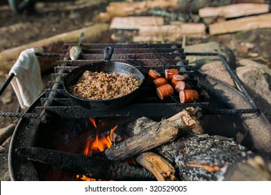 Camp Cooking, Grains And Sausage Cooking Over The Fire